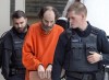 Matthew Raymond is escorted from provincial court in Fredericton on Friday, Feb. 8, 2019. The jury hearing the trial into the shooting deaths of four people in Fredericton in 2018 has been shown more videos and pictures from the computer of the accused. THE CANADIAN PRESS/Andrew Vaughan