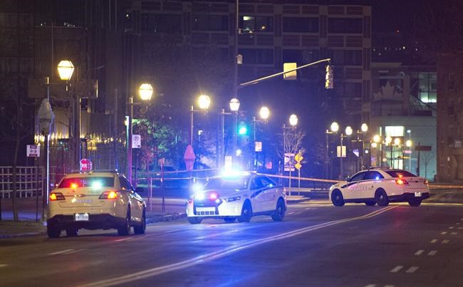 Police cars block the Quai Saint-Andre sweet where they arrested a man in medieval disguise, early Sunday, November 1, 2020 in Quebec City. Two people are dead and five people were injured after they were stabbed. THE CANADIAN PRESS/Jacques Boissinot