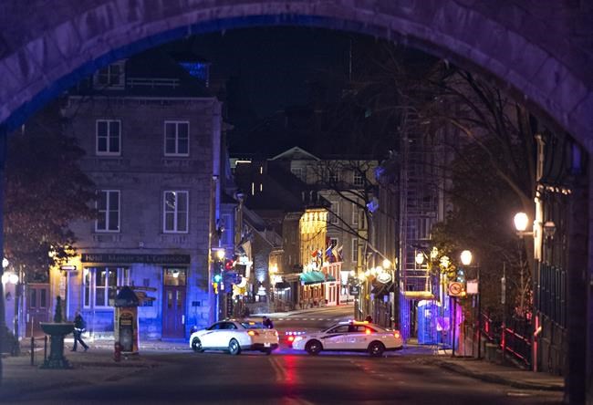 Police cars block the Saint-Louis Street near the Chateau Frontenac, early Sunday, November 1, 2020 in Quebec City. Extra mental health supports are available for those in Quebec's capital, which was shaken by a deadly sword attack on Halloween night. THE CANADIAN PRESS/Jacques Boissinot
