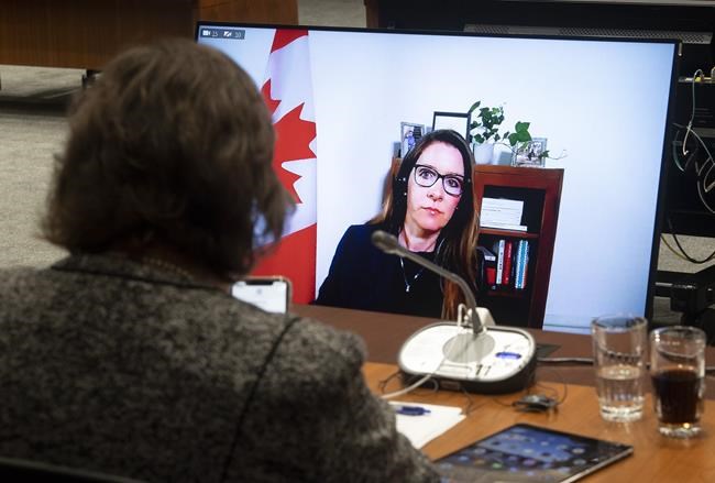Katie Telford is seen on a television before appearing as a witness before the House of Commons Defence committee in Ottawa, Friday May 7, 2021. THE CANADIAN PRESS/Adrian Wyld