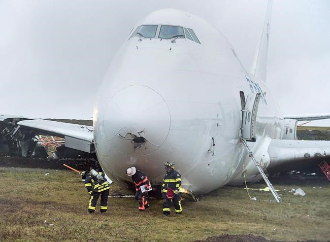 A SkyLease Cargo plane skidded off a runway at Halifax Stanfield International Airport and stopped near a road early on Wednesday, Nov. 7, 2018. The Transportation Safety Board says several factors contributed to a 2018 runway overshoot in Halifax that destroyed a Boeing 747 cargo jet. THE CANADIAN PRESS/Andrew Vaughan