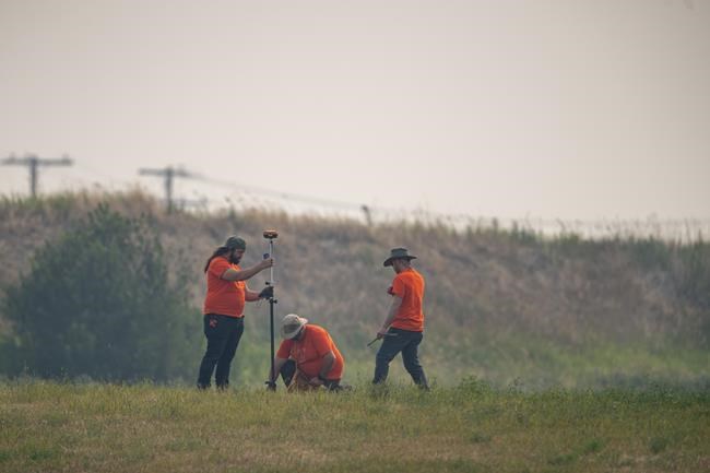 SNC Lavalin engineers use equipment to conduct a search of the grounds at the site of a former Residential School in Delmas, Sask., Saturday, July 17, 2021. THE CANADIAN PRESS/Liam Richards