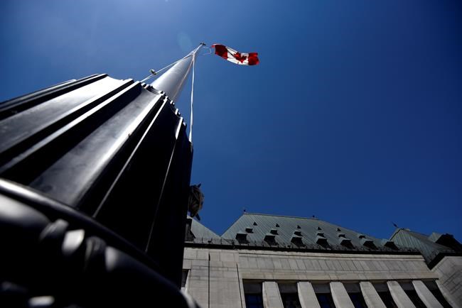 The flag flies in front of the Supreme Court of Canada in Ottawa, on Thursday, June 17, 2021. The Supreme Court of Canada has agreed to hear a case that hinges on the time police took to arrange a breath test for a Quebec man. THE CANADIAN PRESS/Justin Tang