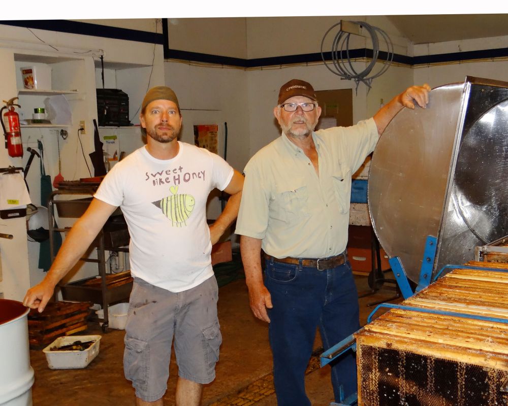 WES KEATING / THE CARILLON
Gary and Art Bergmann at the extractor in the Bergmann honey house.