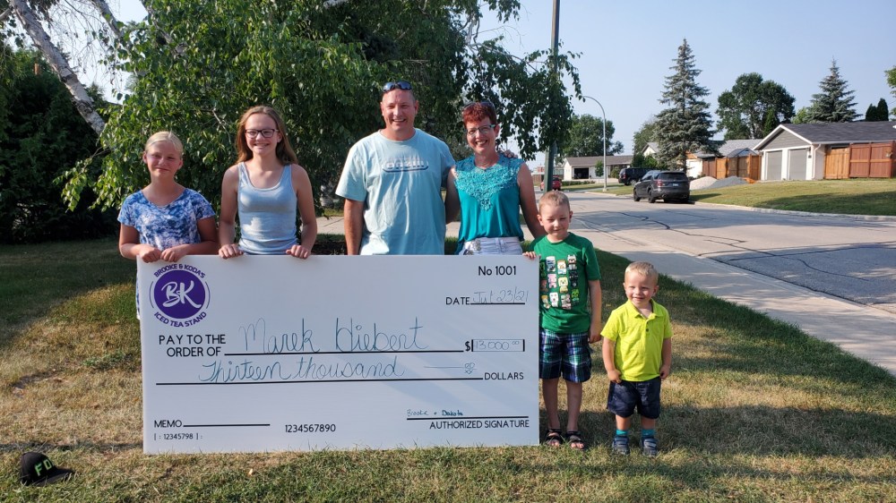 SUBMITTED BY MELISSA PETERS
Brooke Peters and Koda Reimer present a cheque for $13,000 to Marek Hiebert and his family. Hiebert, 6, is undergoing treatment for leukemia.