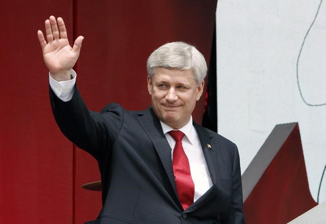 Prime Minister Stephen Harper waves after addressing the Canada Day crowd on Parliament Hill in Ottawa, Wednesday July 1, 2015. THE CANADIAN PRESS/Fred Chartrand
