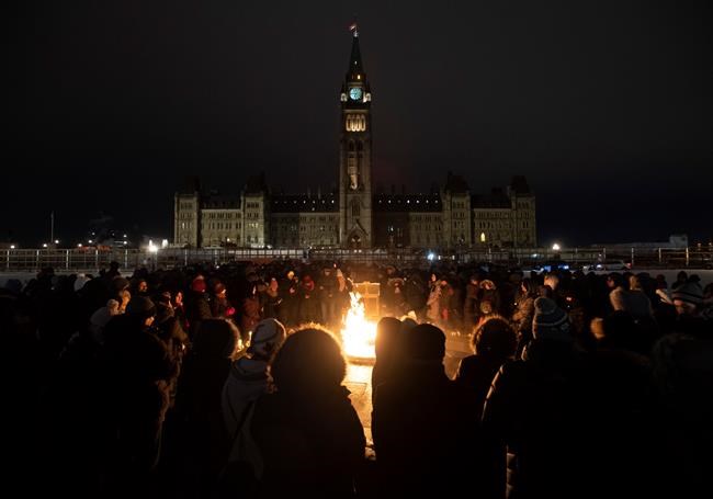 Several hundred people gather around the Centennial flame for a candle light vigil to remember those killed on Ukraine International Airlines Flight on Thursday January 9, 2020 in Ottawa. Among the many painful details that have emerged about the downed airliner in Iran is the preponderance of young victims, and their deaths have sent waves of grief through schools and university campuses across the country. THE CANADIAN PRESS/Adrian Wyld