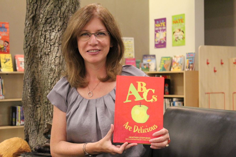 JORDAN ROSS | THE CARILLON
Heather Stephens displays her latest book, ABCs Are Delicious, in Steinbach’s Jake Epp Library. She and illustrator Cyndi Stephens will launch the book this Sunday at 2 p.m. at McNally Robinson Booksellers.
