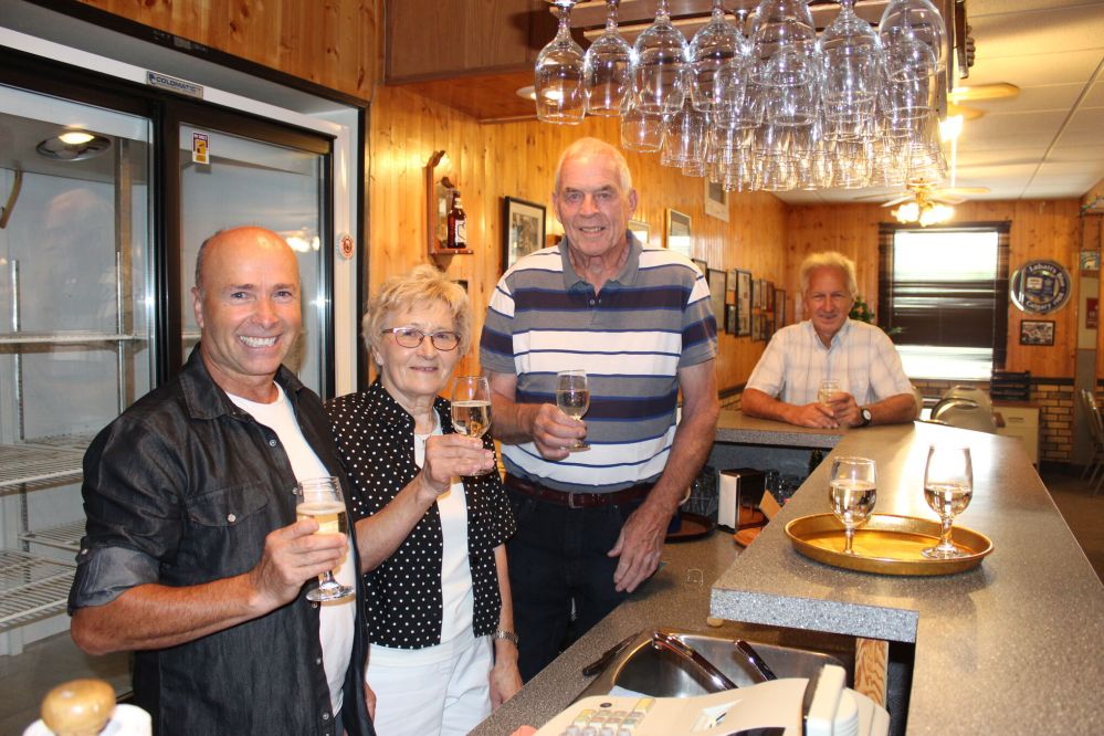 JORDAN ROSS / THE CARILLON
New owner Ben Holodryga, sellers Adele Kolodzinski-Mayberry and Ian Mayberry, and realtor Wayne Arseny toast the sale of Elsie’s Hotel with a glass of champagne in the beverage room.