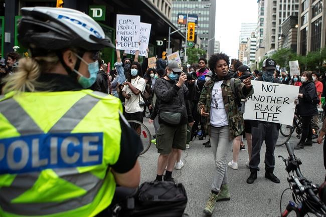 Demonstrators take part in a rally protesting the death of Regis Korchinski-Paquet in downtown Toronto, Saturday May 30, 2020. Korchinski-Paquet, 29, fell from the balcony of a 24th-floor Toronto apartment while police were in the home. THE CANADIAN PRESS/Chris Young