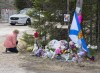 Family members of people killed during the Nova Scotia mass shooting are seeking to launch a class action against the RCMP and the province, arguing police failed to provide adequate protection and information to the public during the attacks. A woman pays her repects at a roadblock in Portapique, N.S. on Wednesday, April 22, 2020. THE CANADIAN PRESS/Andrew Vaughan