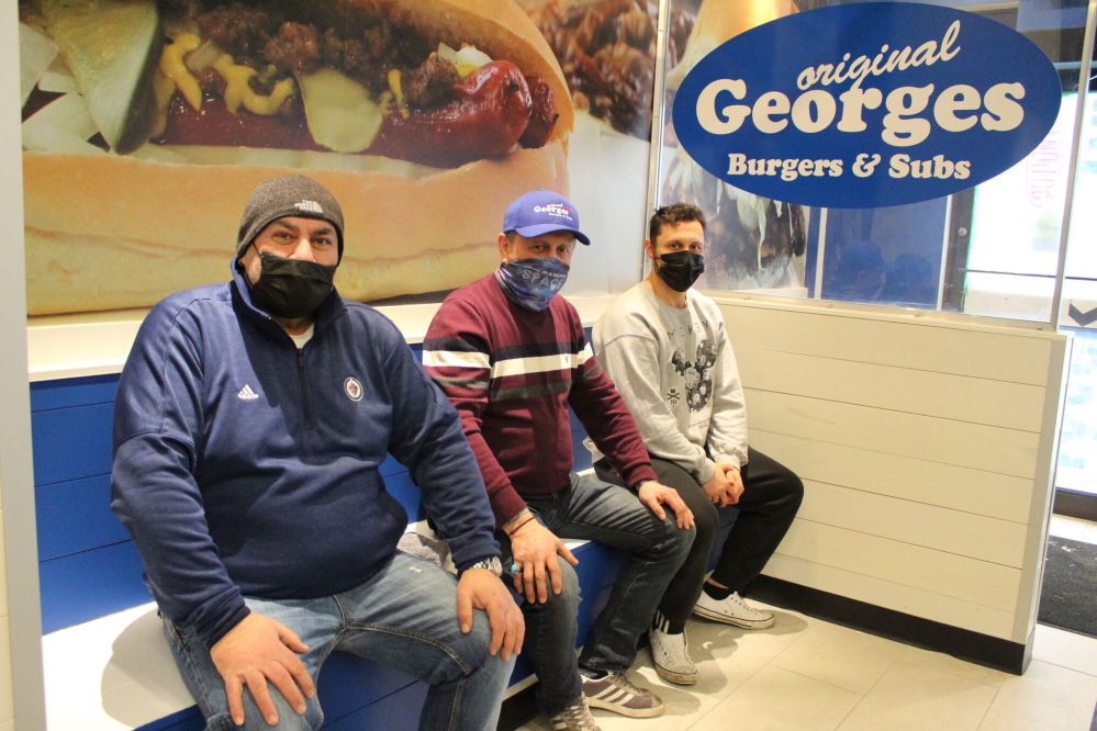 Jordan Ross
Georges Burgers and Subs franchisee Kos Simeonidis, founder and namesake George Ifandis, and son Dimitri Ifandis check out the restaurant’s new Steinbach location on Feb. 27.