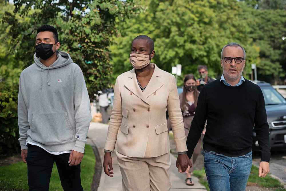 Annamie Paul holds hands with her husband, Mark Freeman, as they walk alongside their son, after a press conference announcing she is officially stepping down as Green Party leader, at Suydam Park in Toronto on, Monday, September 27, 2021. THE CANADIAN PRESS/ Tijana Martin