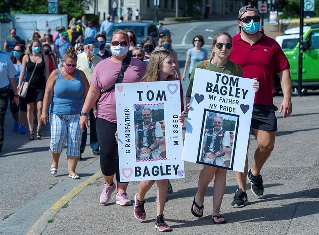 Family and friends of victims of the deadly Nova Scotia mass shootings display their appreciation after an inquiry was announced, in Halifax on Wednesday, July 29, 2020. The federal and provincial governments will launch an inquiry instead of a review that had no power to compel testimony or deliver binding recommendations. THE CANADIAN PRESS/Andrew Vaughan