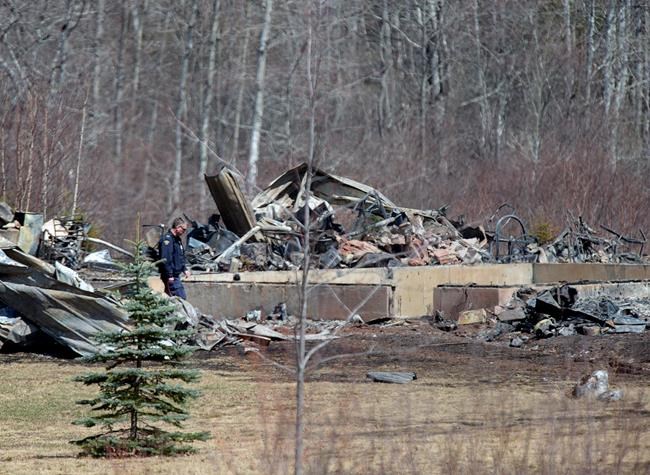 An RCMP investigator inspects a house destroyed by fire at the residence of Alanna Jenkins and Sean McLeod, both corrections officers, in Wentworth Centre, N.S. on Monday, April 20, 2020. A neighbour, Tom Bagley, was also killed on the property. Police say at least 19 people are dead, including RCMP Const. Heidi Stevenson, after a man, driving a restored police car, went on a murder spree in several Nova Scotia communities. THE CANADIAN PRESS/Andrew Vaughan