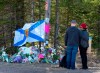 A couple pays their respects at a roadblock in Portapique, N.S. on Wednesday, April 22, 2020. Premier Stephen McNeil says if panellists leading a review into Nova Scotia's recent mass shooting need more powers, he expects they will request them from his government. THE CANADIAN PRESS/Andrew Vaughan