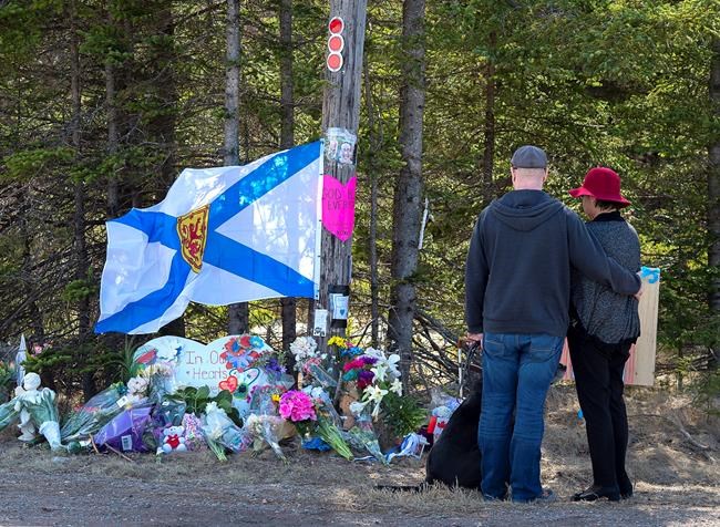 A couple pays their respects at a roadblock in Portapique, N.S. on Wednesday, April 22, 2020. Premier Stephen McNeil says if panellists leading a review into Nova Scotia's recent mass shooting need more powers, he expects they will request them from his government. THE CANADIAN PRESS/Andrew Vaughan