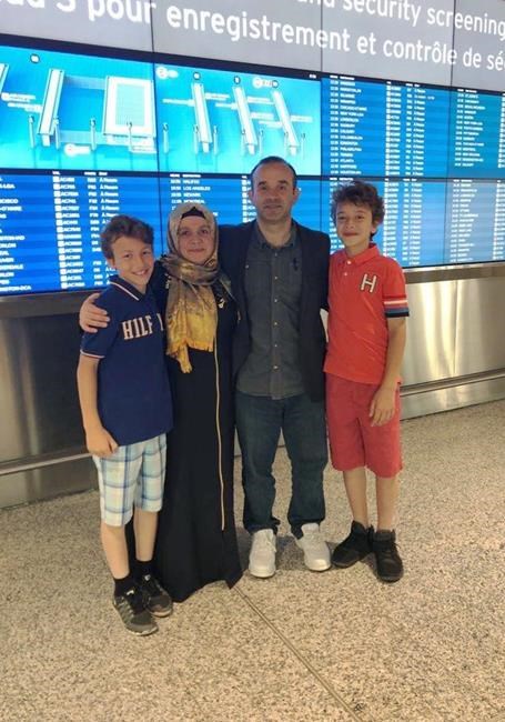 Davud Hanci is greeted by his wife Rumeysa Hanci and their sons Vedat, 13, and Cemil, 12, at Toronto's Pearson International Airport in a July, 2019 handout photo. Davud Hanci would tell inmates to treat their time as valuable when he was working as a chaplain in Alberta prisons and jails. The imam tried to follow his own advice during the nearly three years he spent confined alone in a Turkish prison cell on allegations that he helped orchestrate an attempted military coup. THE CANADIAN PRESS/HO, *MANDATORY CREDIT*