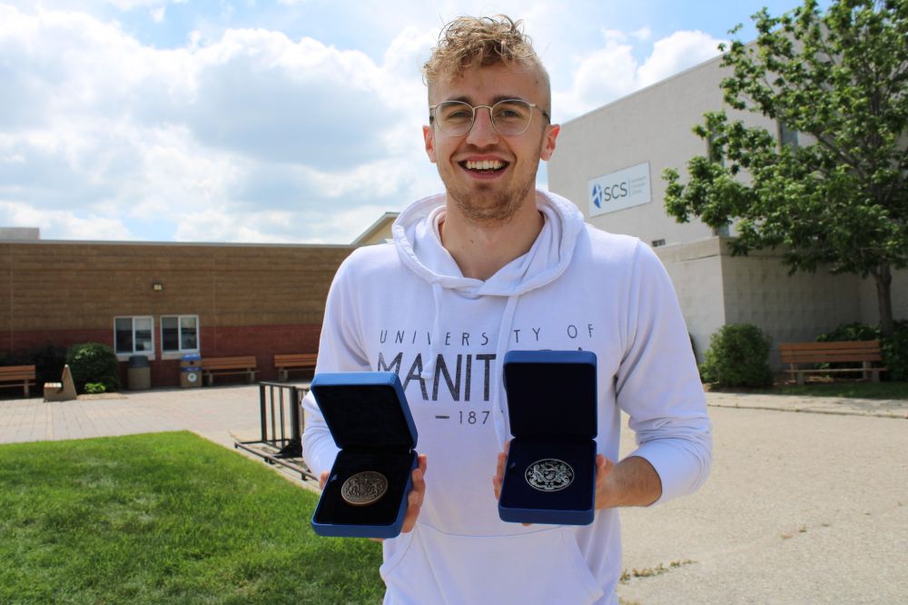 Greg Vandermeulen
Kasidy Harder shows the two Governor General’s Awards he won, in front of his former school, Steinbach Christian High School.