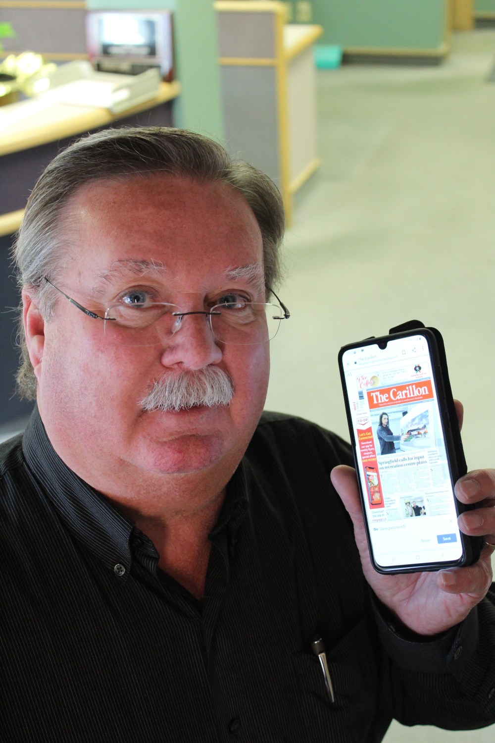 Greg Vandermeulen
The Carillon publisher Laurie Finley shows off another way to read your weekly newspaper.