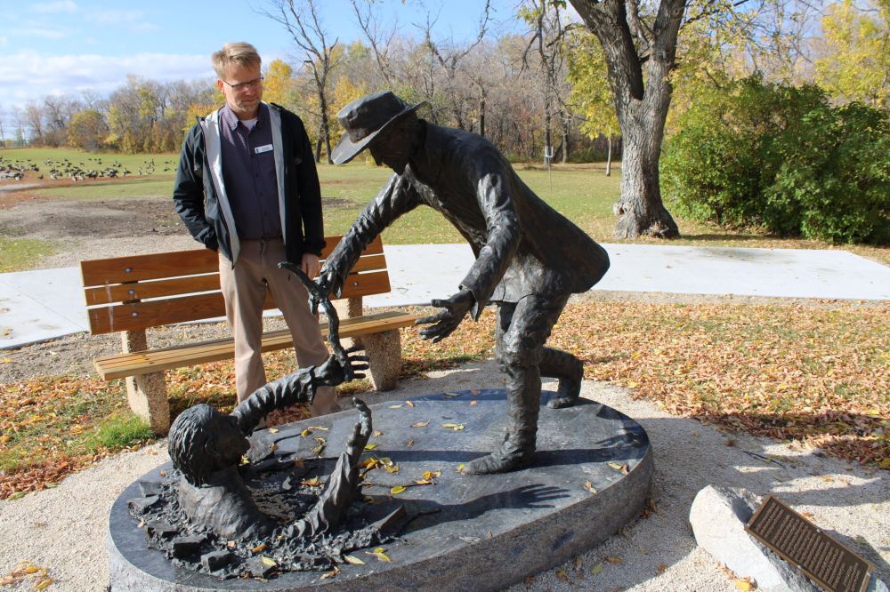 Greg Vandermeulen
Mennonite Heritage Village Executive Director Gary Dyck looks at the sculpture created by Peter Sawatzky, of Dirk Willems rescuing his captor. That sculpture is the centerpiece for the Dirk Willems Peace Garden that organizers hope to create with funds from a recently launched Kickstarter campaign.