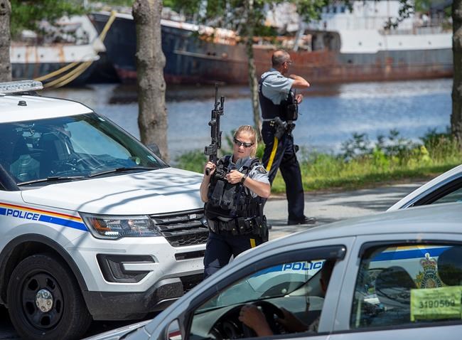 RCMP officers maintain a roadblock as they search for a suspect after a Bridgewater Police Service officer was stabbed as he responded to a domestic violence complaint at The Bridgewater Hotel in Bridgewater, N.S. on Tuesday, July 21, 2020. The search continues today around the Bridgewater, N.S., area for the man suspected of domestic assault, stabbing a police officer in the neck and later injuring a police dog.THE CANADIAN PRESS/Andrew Vaughan