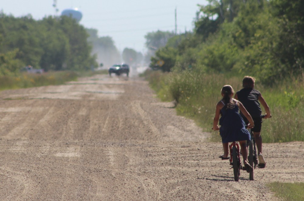 Josh Greschner
Lazy, midday bike riding west of Steinbach along McKenzie Ave/Road 35N. An application to subdivide land north of nearby Country View School to build a church came to the RM of Hanover at the June 24 council meeting. A provincial department objected to the application but Hanover manager of planning Jeremy Neufeld said the application complied with relevant rules.