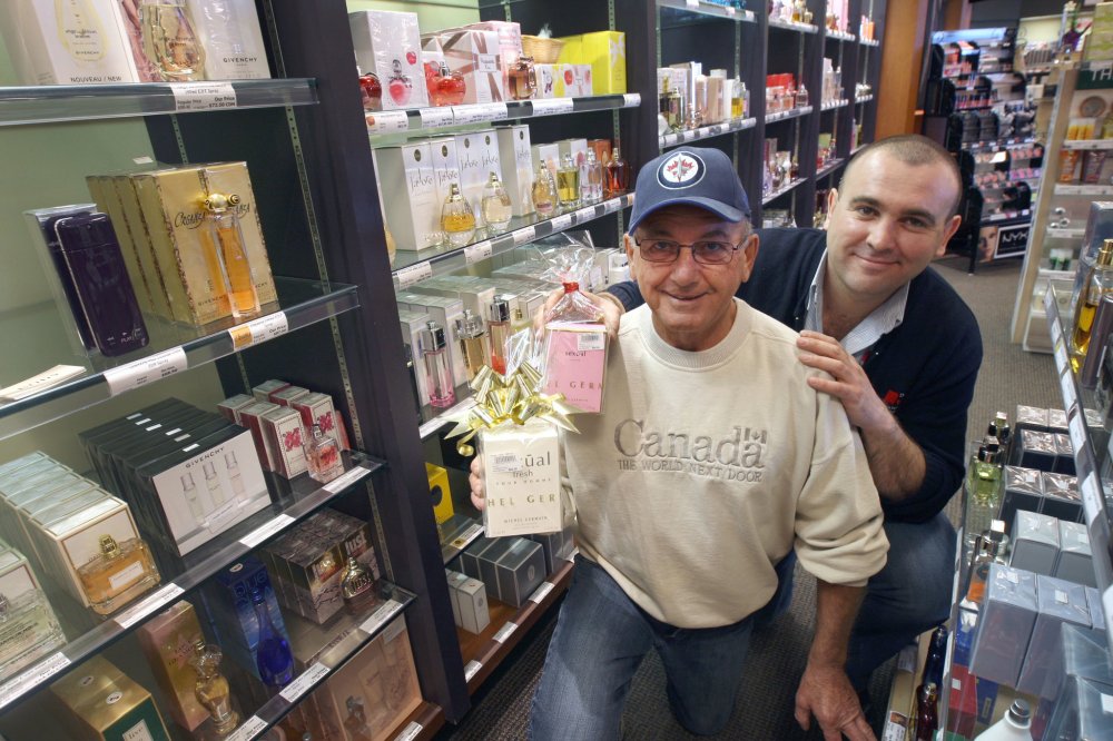 JOE BRYKSA | WINNIPEG FREE PRESS
Michael Resch, left, with his son Simon, the manager of the Emerson Duty Free Shop selling gift items, alcohol and smokes. The elder Resch is being recognized by the Canadian Tourism Hall of Fame.