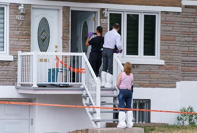 Police investigate the scene where a six-year-old girl was stabbed overnight and later died in Montreal on Thursday, July 23, 2020. Montreal police said today they are considering her death a homicide. THE CANADIAN PRESS/Paul Chiasson