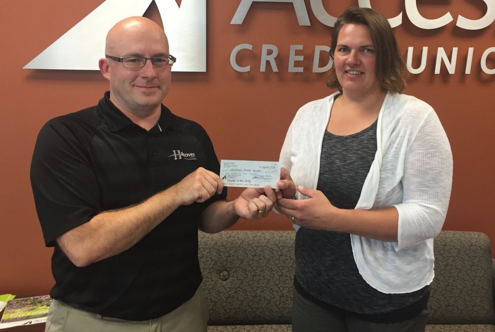 SUBMITTED PHOTO
2016 Allan Cup secretary treasurer Luc Lahaie hands a $1,500 cheque to Saskia Reutter, president of Grunthal Minor Hockey. The local association is one of three minor hockey groups sharing some of the profit from the Allan Cup Steinbach hosted.