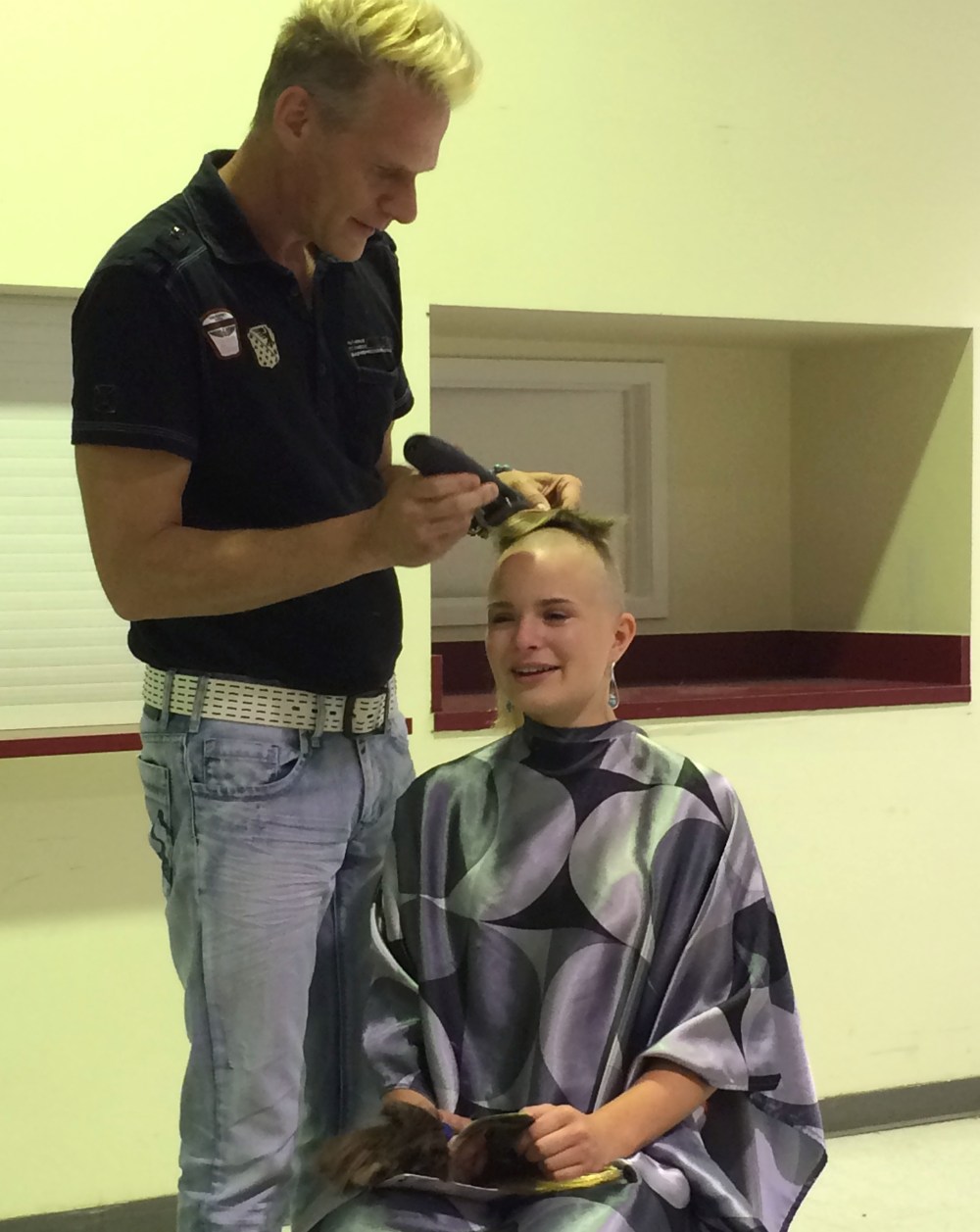 SUBMITTED PHOTO
Nadine Mendel loses her long hair which will be turned into a hair piece for children living with cancer. Her long-time hair stylist Jeff Broesky carefully clips and snips in front of supporters cheering on the teen who continues to raise funds for the Canadian Cancer Society.