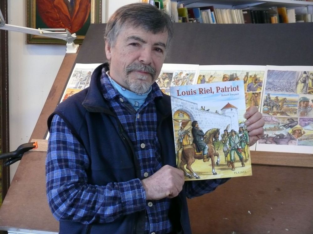 ADRIANA MINGO | THE CARILLON
Visual artist Robert Freynet holds a copy of his graphic novel Louis Riel, Patriot in his Ste Genevieve studio.