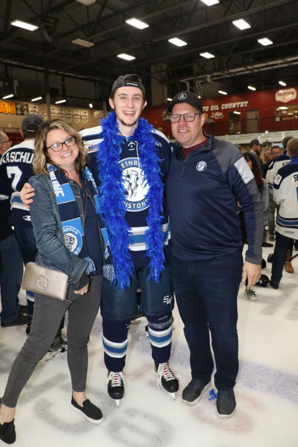 Supplied photo
Stacy and Sheldon Froese, who have billeted Pistons players for six years, pose with their former billet, defenceman Mark Wilson after the Pistons won the 2017-18 MJHL championship in Virden.