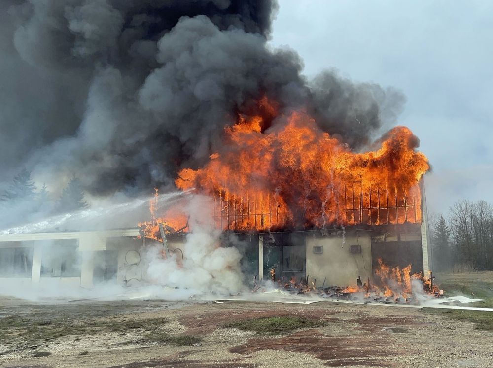 REYNOLDS FIRE DEPARTMENT
Flames consume the McMunn Motor Inn along the Trans-Canada Highway on Sunday. RCMP are calling the fire suspicious.