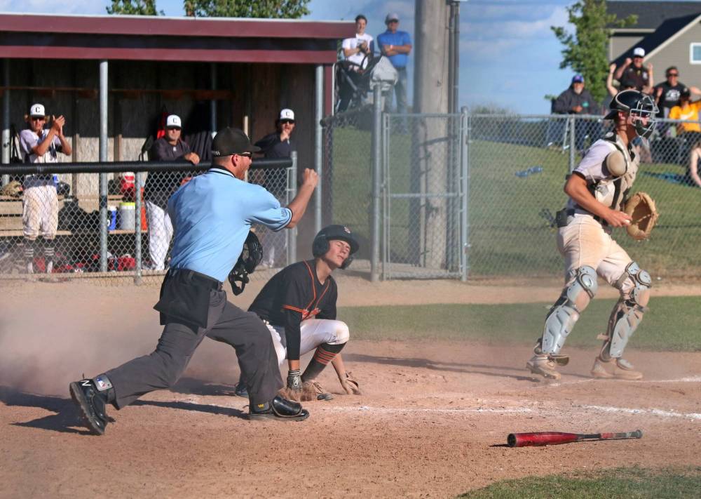 A Winnipeg South player winces as he's called out at home after an attempt at tagging up on a long fly ball. Cody Gunderson not only made this tag, but threw out two attempted steals from Winnipeg South during the final.