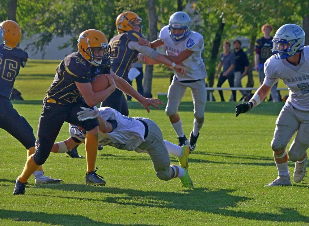 Austin Neufeld breaks a tackle on his way to the endzone for a first half touchdown for the Steinbach Regional Secondary School Sabres in high school football action Sept. 9. Neufeld led the Sabres ground attack, racking up 93 yards and two touchdowns on 11 carries. (Cassidy Dankochik The Carillon)