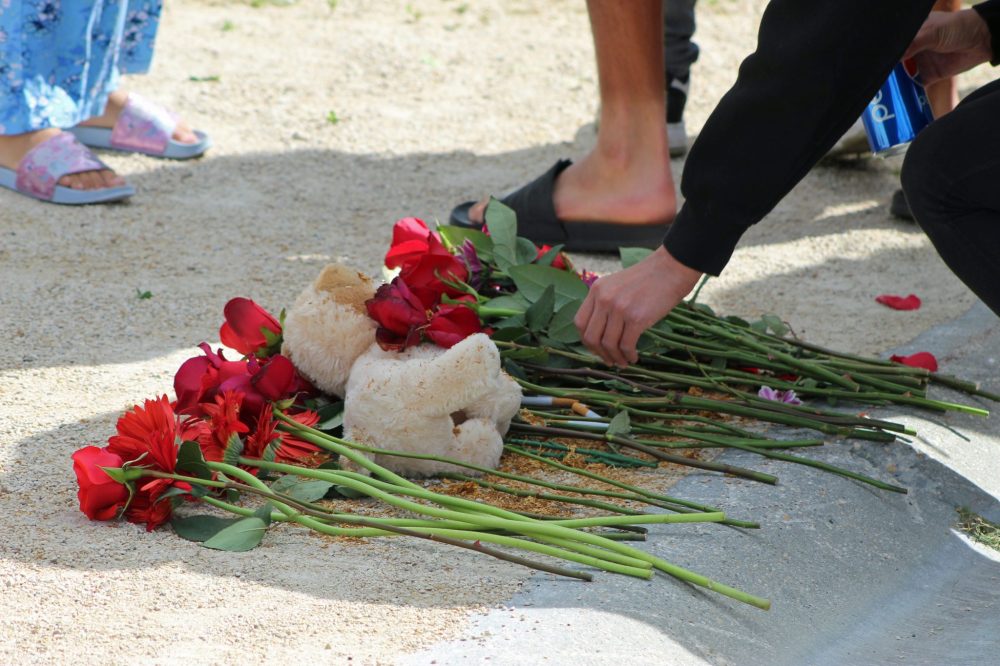 JORDAN ROSS THE CARILLON
As the vigil concluded, people filed past the end of the driveway to place flowers and sprinkle tobacco.