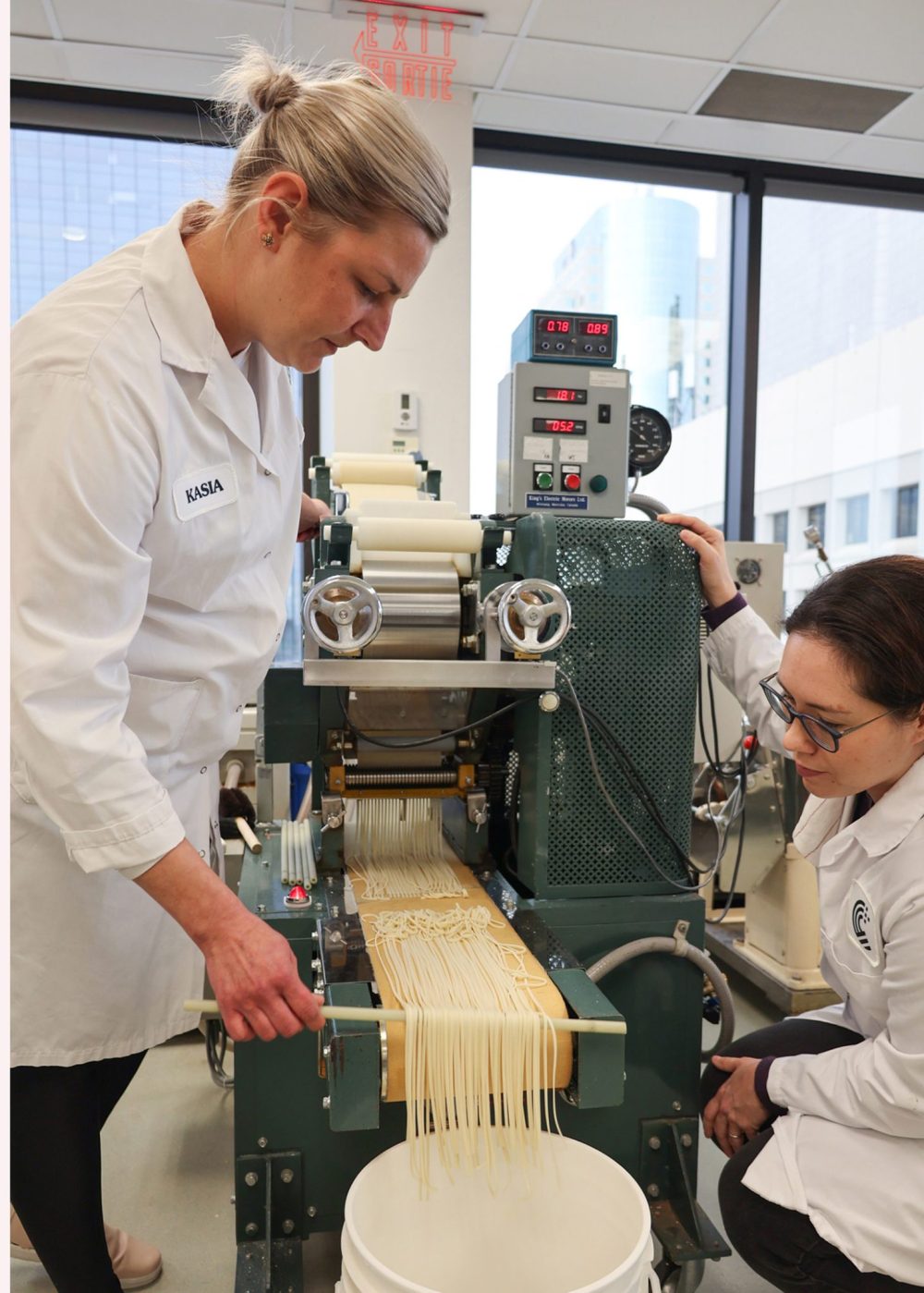 LEE HUSCROFT CEREALS CANADA
Kasia McMillin and Natalie Middlestead at the noodle making equipment on the 11th floor of Cereals Canada’s building on Main Street.