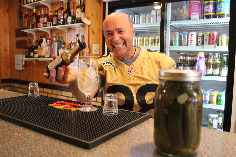 Ben Holodryga mixes a Caesar cocktail behind the bar at Elsie’s Hotel in Tolstoi. (JORDAN ROSS | THE CARILLON)