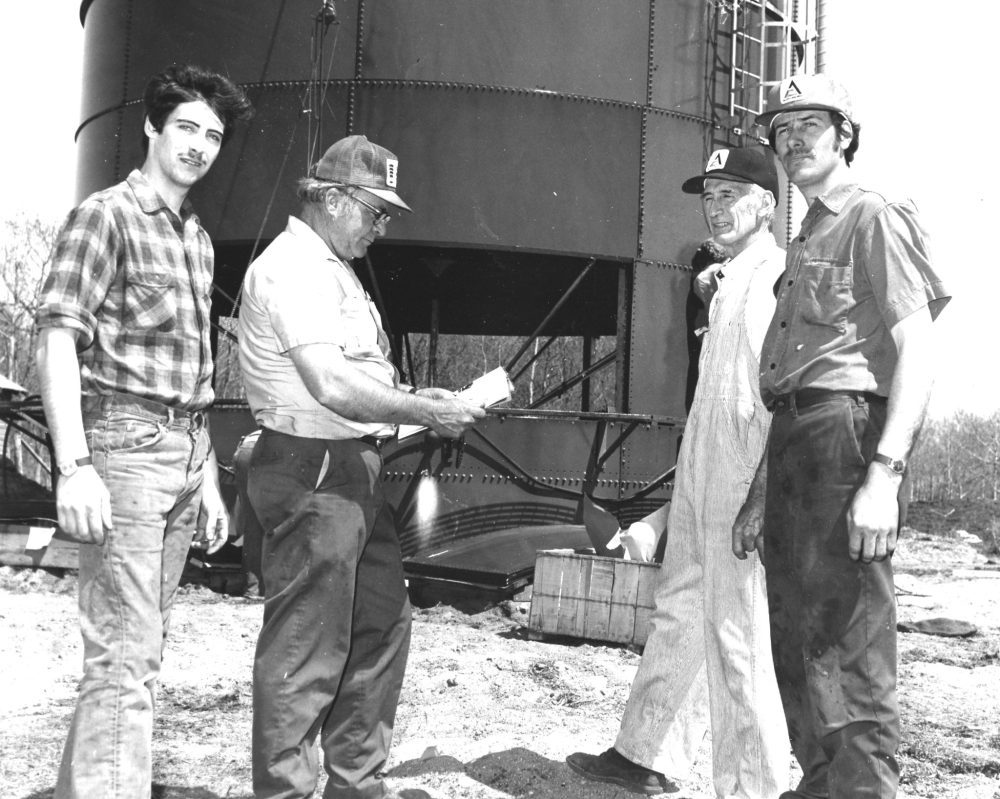 CARILLON ARCHIVES
The Frechettes, David, Armand and Leo, discuss plans for their new silo with construction foreman Lloyd Verley, centre, at their La Broquerie dairy farm in 1975.