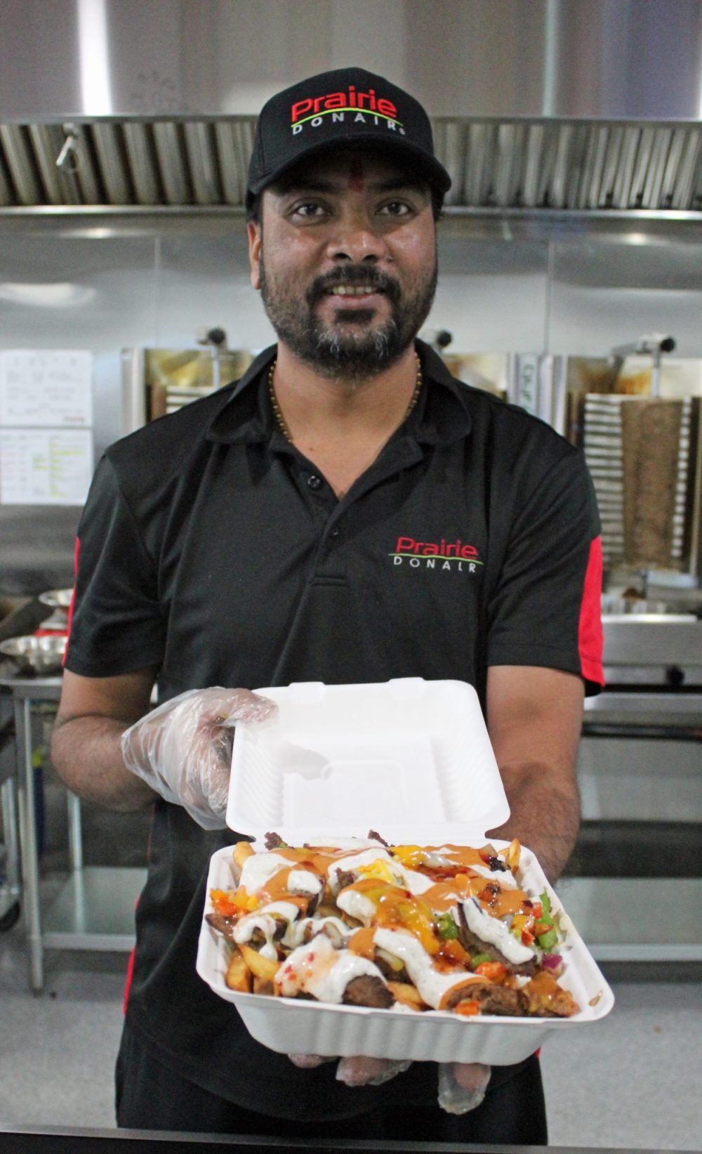 JORDAN ROSS THE CARILLON
Prairie Donair owner Jay Pansuriya with a PD Famous Skillet, the most popular menu item in Steinbach so far.