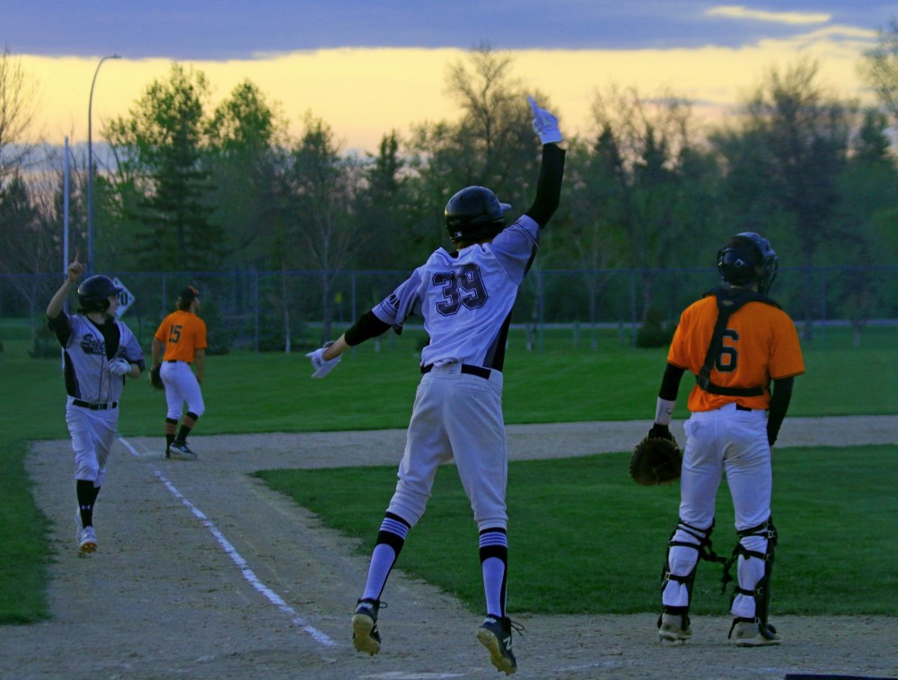 Carillon players celebrate tying a game in the seventh inning against Winnipeg South earlier this year. After the seventh inning was completed, the game was halted due to darkness, one of ten games the Sutlans need to make up this season. (Cassidy Dankochik Photo - The Carillon)