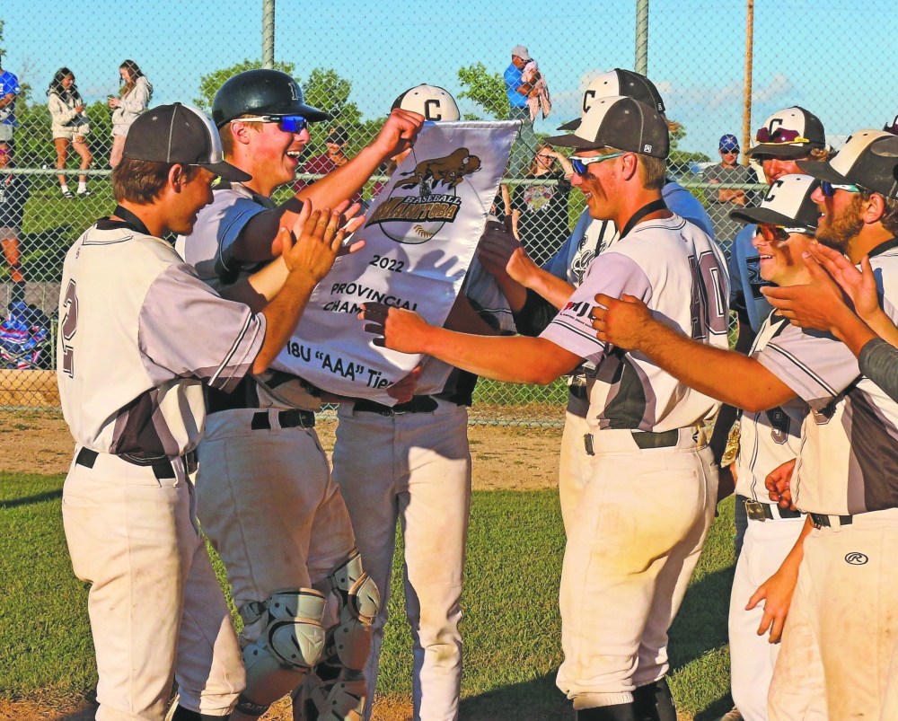 The Carillon Sultans celebrate with the banner signifying their spot as the best 18U AAA team in Manitoba. (Cassidy Dankochik The Carillon)
