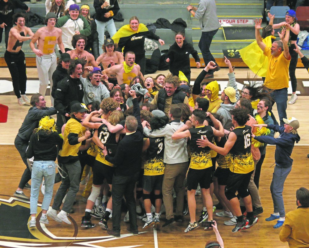 Steinbach fans mob the Sabres team after the final point hit the floor. Steinbach fans dominated the stands, appearing to vastly outnumber their St. Paul's counterparts at the provincial AAAA volleyball finals. (Cassidy Dankochik The Carillon)
