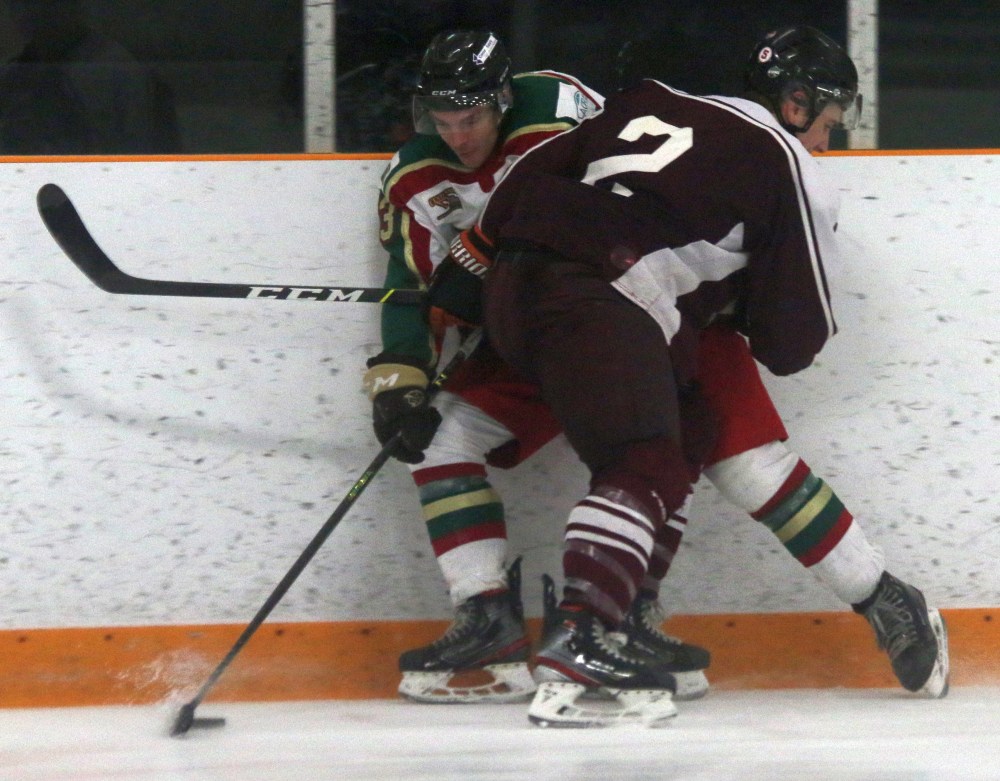 Thomas Freeman tries to squeeze by Altona's Adam Henry in Ile des Chenes final regular season game of the season. Henry was honoured by the SEMHL before the game, named as the league's top defenseman for the second consecutive year. The North Stars would go onto win 13-3, in a game that cemented their spot in the standings and a first round matchup against Morden. (Cassidy Dankochik The Carillon)