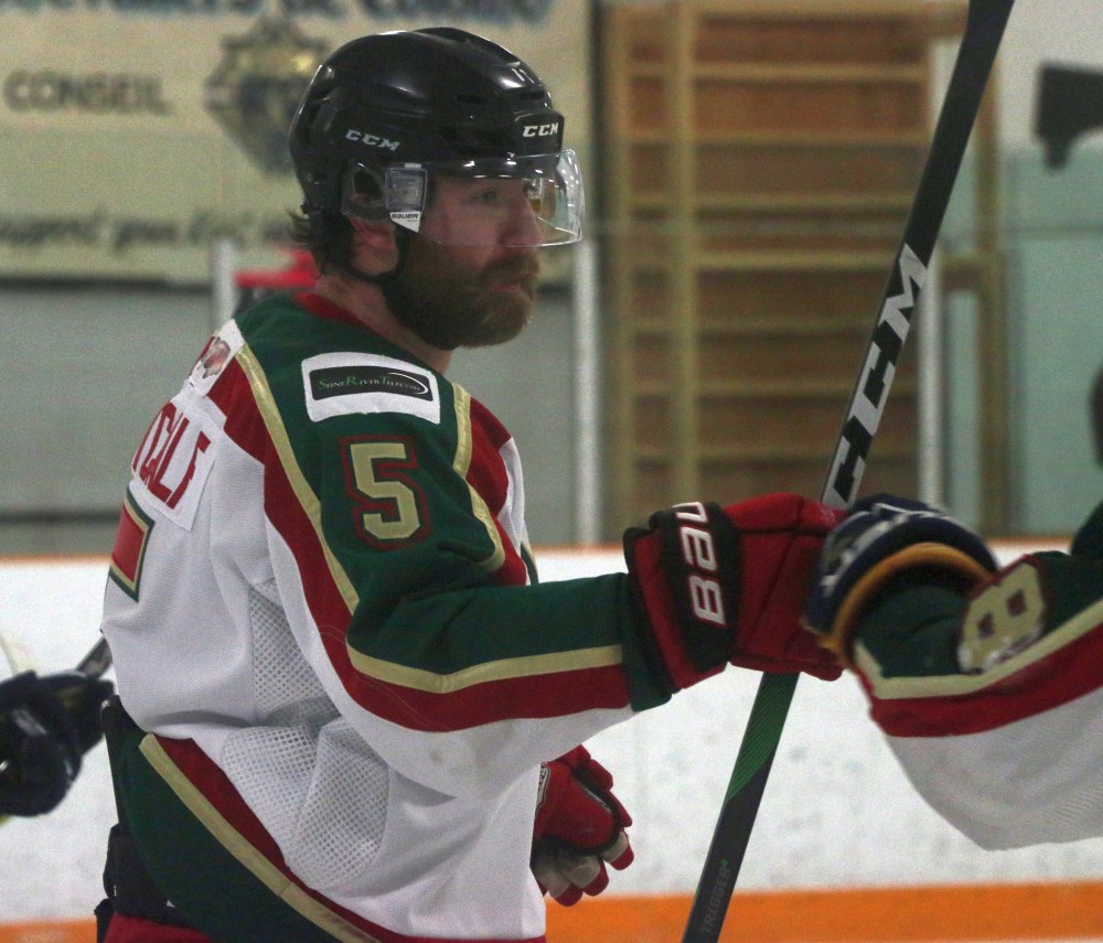 Justin Metcalf gets a fist-bump after picking up a goal in Ile des Chenes' final regular season game of the season. (Cassidy Dankochik The Carillon)