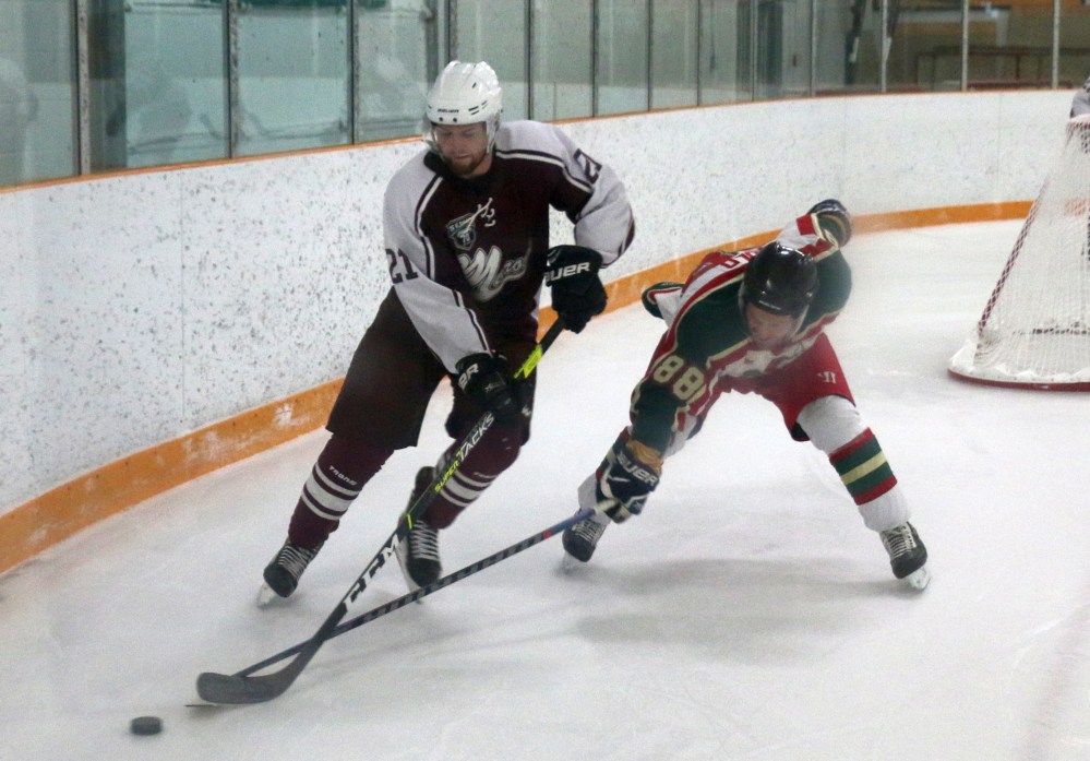 Brent Wold stretches for a puck while forechecking during a game against Altona Feb. 5. Wold finished with a goal and two assists in a 13-3 victory. (Cassidy Dankochik The Carillon)