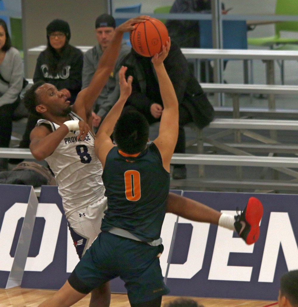Emmanuel Oleko flies for block against CMU Jan. 27. The Providence Pilots were able to pick up consecutive wins against the Blazers, including 75-68 in Niverville. (Cassidy Dankochik The Carillon)