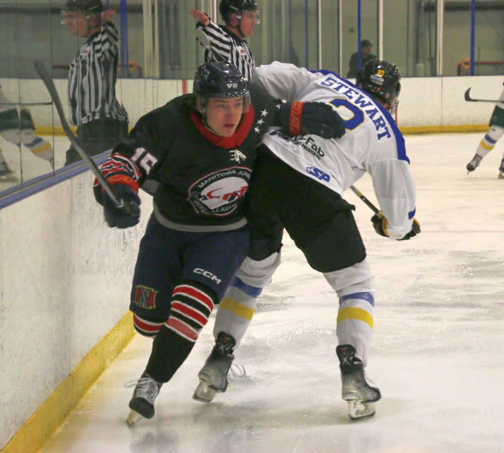 Niverville's Josh Paulhus dodges a check from Flin Flon Bomber Reece Richmond. Flin Flon, located on the Manitoba/Saskatchewan boarder, plays in the SJHL. (Cassidy Dankochik The Carillon)