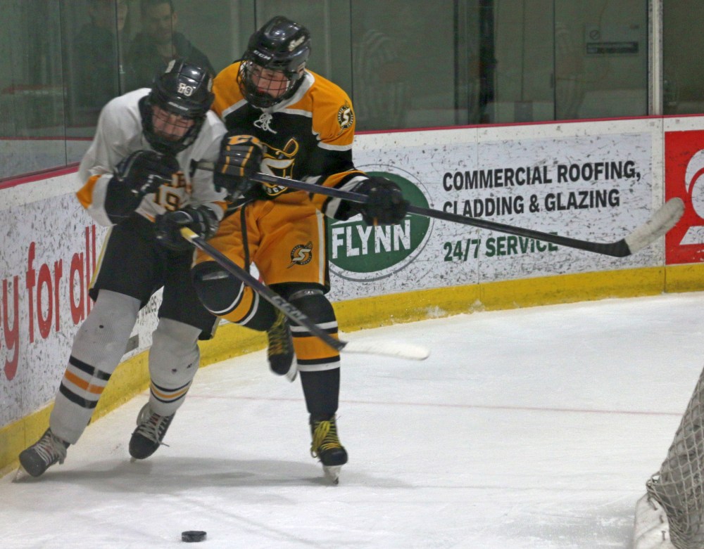 Lucas Jolicoeur delivers a hard check in the third period. The Sabres played a grinding, physical game, bullying their opponents in a tight-checking victory. (Cassidy Dankochik The Carillon)